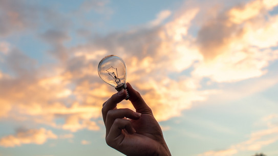 A light bulb in front of a sunset